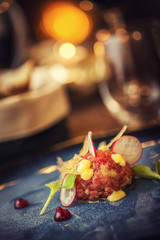 Tartare steak with a glass of wine and hornets, product photography for the restaurant, modern gastronomy