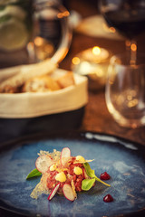 Tartare steak with a glass of wine and hornets, product photography for the restaurant, modern gastronomy