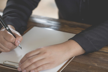 Lady holding pen, it's like a letter writer. Creative idea of work 2019 goals, writing, drawing,making notes in document.Business,investment,concept,Vintage ,Retro natural mood style. soft focus.