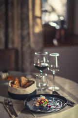 Tartare steak with a glass of wine and hornets, product photography for the restaurant, modern gastronomy