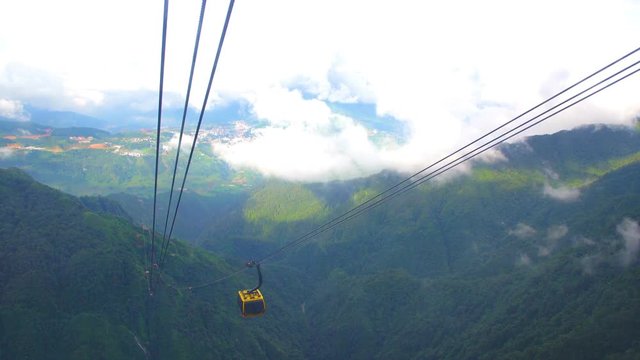 SAPA,LAO CAI/VIETNAM - JULY 26: Cable car in the middle of the valley, fog in cloud background of country going to Fansipan mountain SAPA VIETNAM. on 07 26 2018