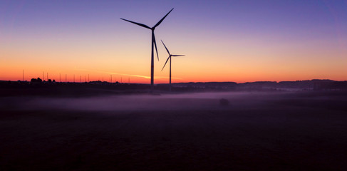 Obraz premium Windmill at Sunset . Wind turbines farm . Wind turbines farm at sunset