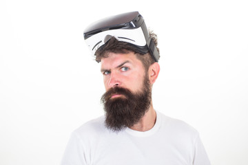 Happy bearded man wearing virtual reality goggles watching movies or playing video games. The man...