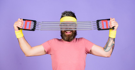 Join my sport class. Sportsman wear retro outfit training violet background. Athlete training with chest expander. Man bearded athlete exercising with expander equipment. Athlete sport instructor