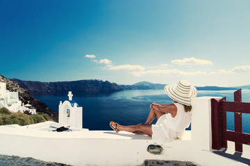 Luxury travel vacation woman looking at view on Santorini island