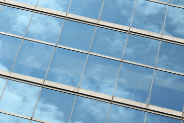 Glas facade with reflection of blue sky and clouds on a business building in Ginza district, Tokyo, Japan