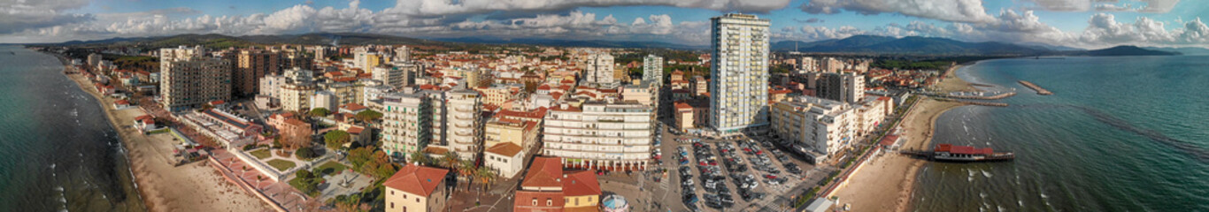 Fototapeta na wymiar Panoramic aerial view of Follonica, Italy. Coastline of Tuscany with town and ocean