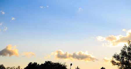 Pink vanilla heaven. Bright blue sky with gentle cumulus clouds. Dawn summer background.