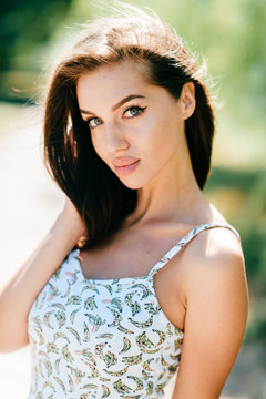 Closeup lifestyle portrait of celebrity female model.  Beautiful girl face on abstract nature background. Cheerful amazing young woman face expression. Sexy blue eyed babe. Glamour youth appearance.