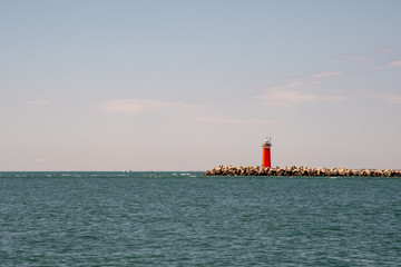 Red lighthouse on the coast of the Adriatic Sea, Veneto, Italy