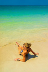 Fototapeta na wymiar Cute woman relaxing on the summer beach.