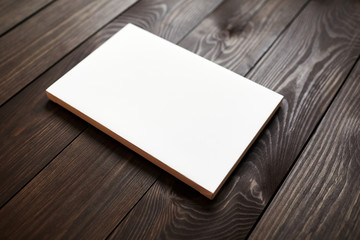 White blank canvas on brown wooden background. Mockup