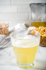Chickpea broth aquafaba, liquid water brine, Replace egg in baking for vegan recipe. Vegan diet drink, white marble background copy space