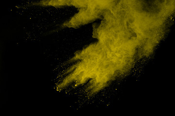 Gold powder particles explosion. Glitter burst with golden texture. Yellow color dust splash for fashion background.