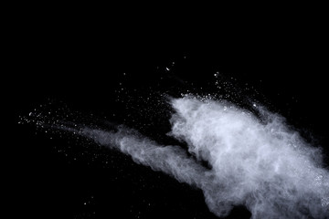 White powder explosion on black background. Dust splatted isolated. Paint Holi.