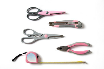 Pink feminine handy tools on a white background