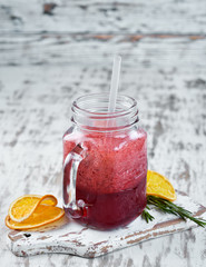 Fresh blended cocktail of currant, blackberry and blueberries. On a wooden background. Top view....