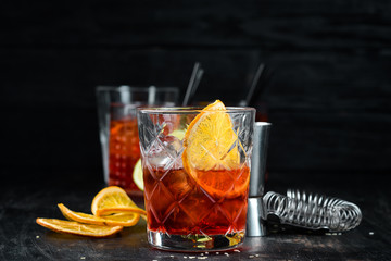 Cocktail Bulvardye. Whiskey and Orange Liquor. Alcoholic cocktail in a glass. On a wooden...