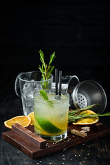 Caipirini with Rom. Alcoholic cocktail in a glass. On a wooden background. Top view. Free copy space.