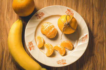 Tasty peeled tangerine on a white plate