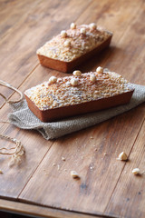 Caramel Hazelnut Financier with Crumble Topping - traditional French cake, on wooden table.  
