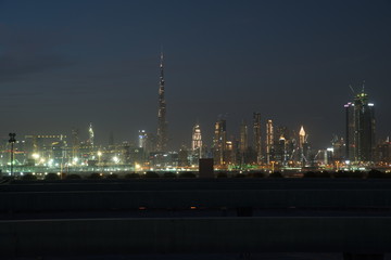 Fototapeta premium Dubai skyline at night from Al Meydan Hotel and district, Dubai downtown and Business Bay area