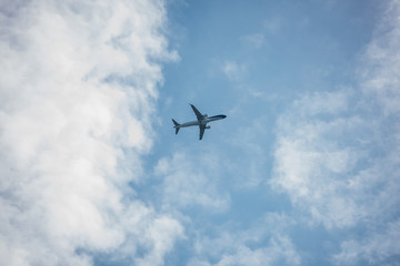 Fototapeta na wymiar Bottom view of flying airplane in sky