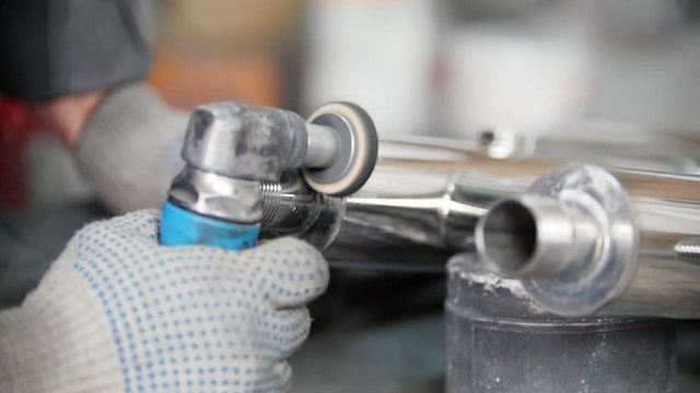 Polishing stainless steel parts at metal factory. Polishing stainless groove
