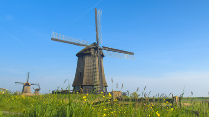CLOSE UP: Beautiful traditional wooden windmill in lowland grassy countryside