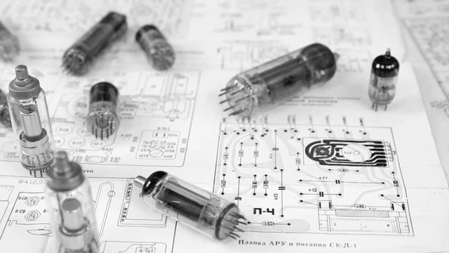 Old electronic vacuum tubes on the electronic schemes, black and white