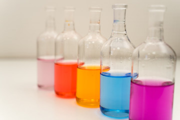 laboratory glassware with liquids of different colors