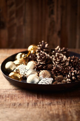 Pine cones and Christmas ornaments on a rustic tray. Rustic Christmas design