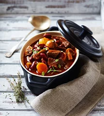 Fototapeten Beef goulash with mushrooms and vegetables. Symbolic image. Concept for a tasty and hearty dish. Bright wooden background   © B.G. Photography
