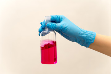 hand in glove holding test tube in the laboratory