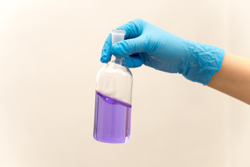 hand in glove holding test tube in the laboratory