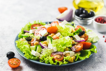 Chickpeas, tomato, cucumber,olives feta salad with lemony dressing. Selective focus, space for text.