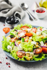 Chickpeas, tomato, cucumber,olives feta salad with lemony dressing. Selective focus, space for text.