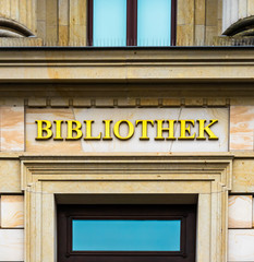 Fototapeta na wymiar Entrance of a library in an ancient building labelled with golden letters.