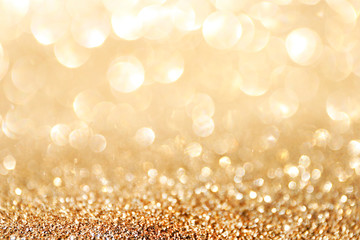Golden sparkle glitters with bokeh effect and selectieve focus. Festive background with bright gold...