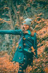 edited portrait of woman throwing leaves