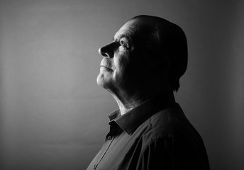 Beautiful older man in front of a colored background