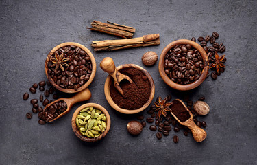 Coffee, anise, cinnamon and nutmeg on black background.