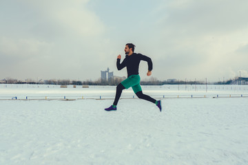 Bearded runner running on snow