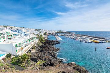old town and port boardwalk with tourists in Puerto del Carmen,