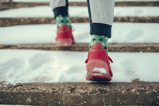 Man In Red Sneakers Walking Up The Snowy Stairs