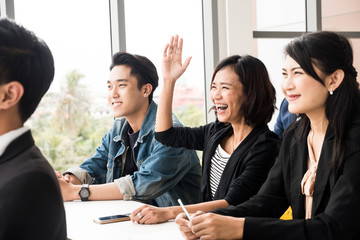 Asian Officers are feeling happy while training together at the office.