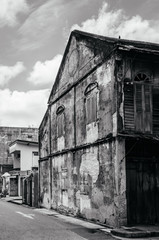 Old grunge Chino-Portuguese Colonial building with timeworn wall at Nang Ngam street, Songkhla - Thailand