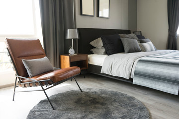 leather armchair and gray carpet in bedroom