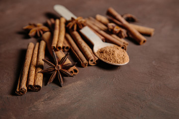 Composition with sweet cinnamon sugar on brown background