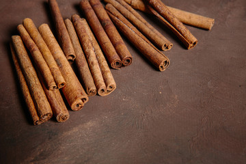 Cinnamon sticks with star anise on brown background. The view from the top. Place for recipe text